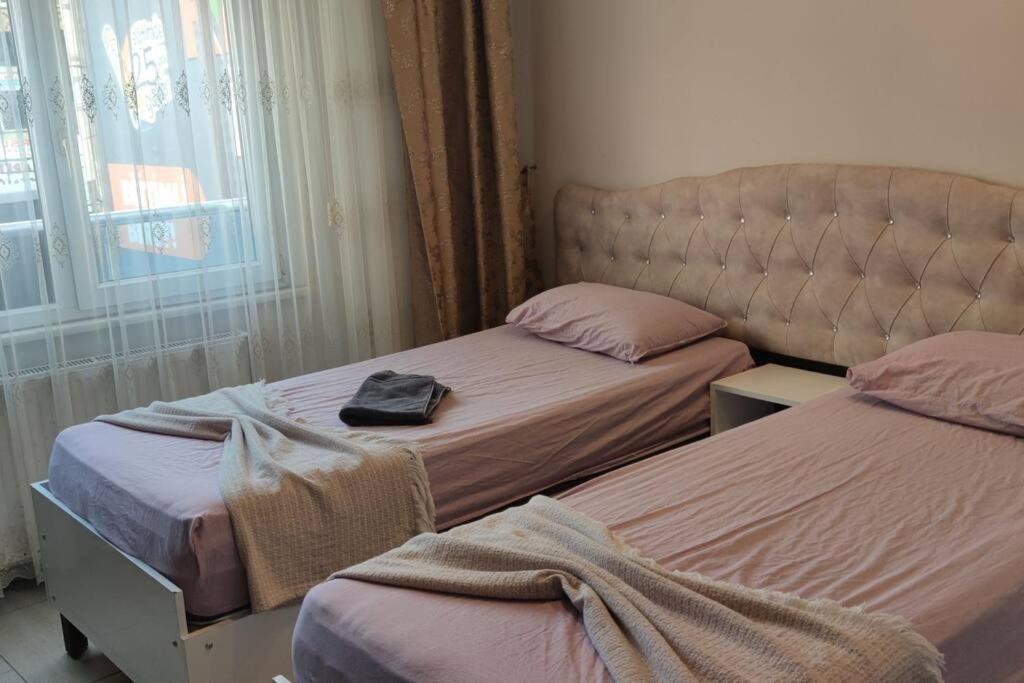 um quarto com duas camas e um saco na cama em Midtown Hotel Apartments 401 (2+1) em Istambul
