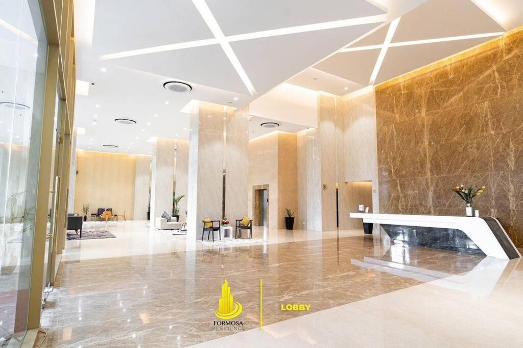 a lobby with a yellow cone in the middle of a room at SLEPTOPIA at formosa lvl27 budget unit city and sea view in nagoya jodoh in Jodoh