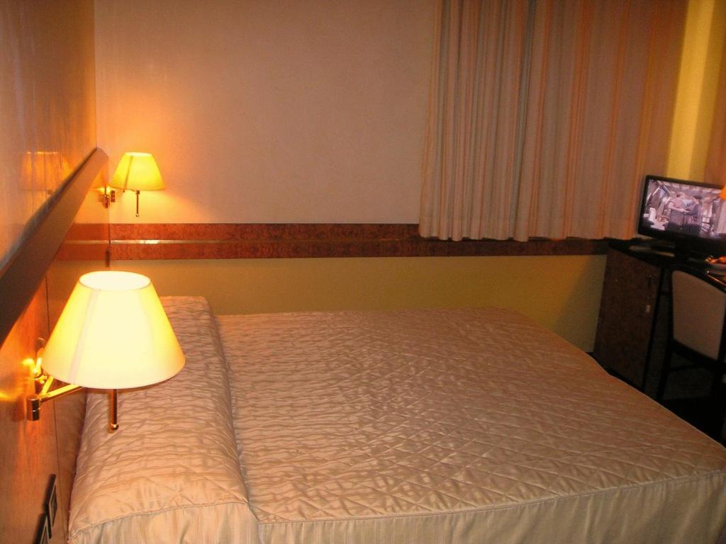 Postel nebo postele na pokoji v ubytování Park Hotel Villa Leon d'Oro