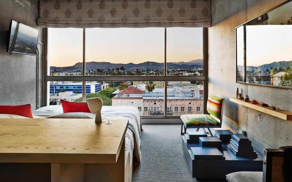a room with a bed and a large window at The LINE Hotel LA in Los Angeles