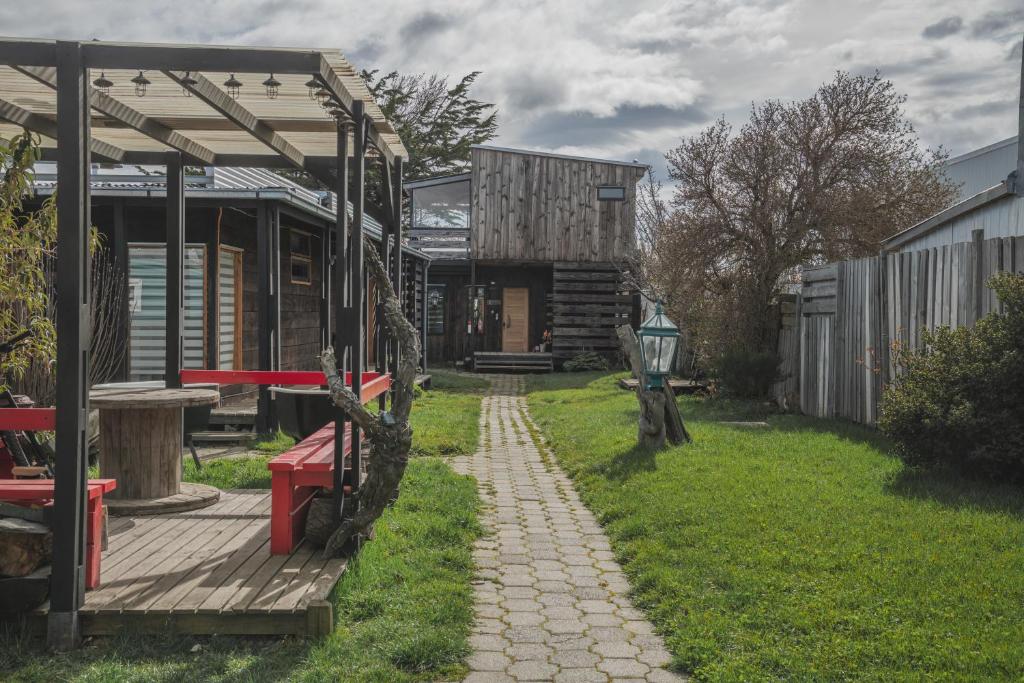 a house with a picnic table and a path leading to it at Toore Patagonia in Puerto Natales
