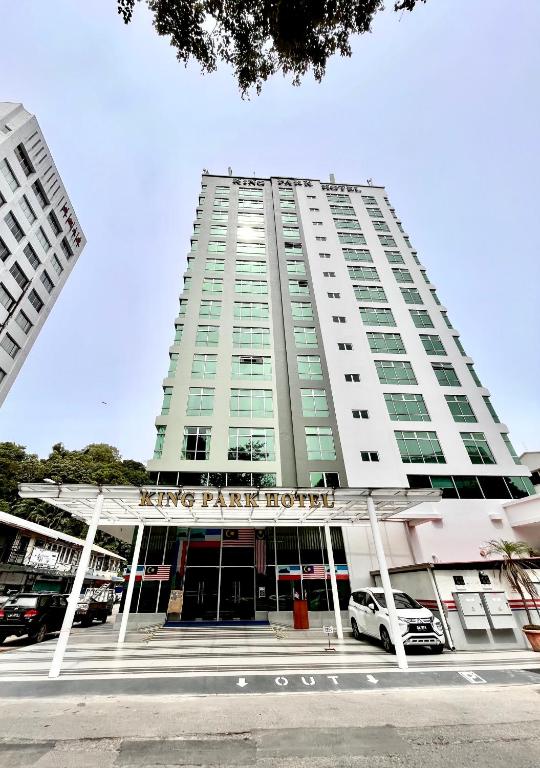 a tall building with a car parked in front of it at King Park Hotel Kota Kinabalu in Kota Kinabalu