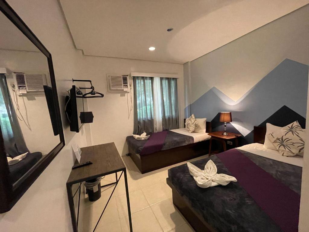TV a/nebo společenská místnost v ubytování Coron Ecolodge