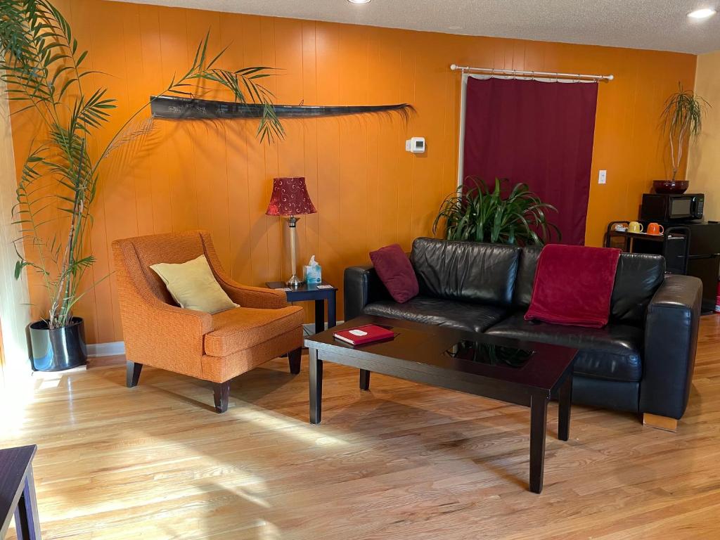 a living room with a leather couch and a chair at Turnagain Guest House in Anchorage