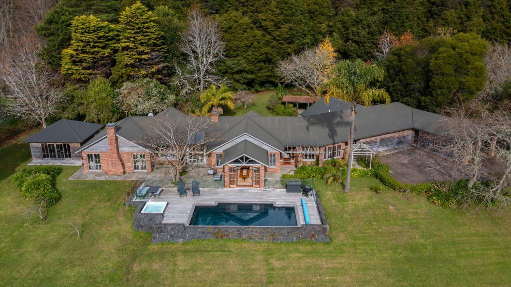 an aerial view of a house with a swimming pool at Peace-Realm Retreat in Matakana