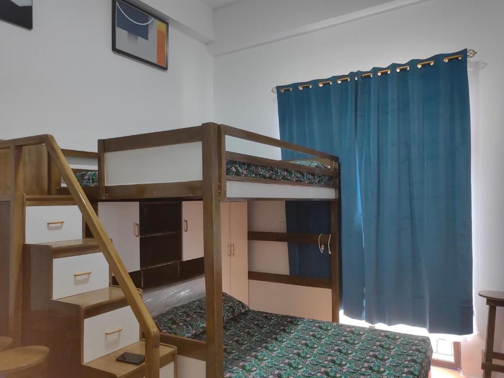 a bunk bed in a room with a ladder at Salcedo's Units in Baguio