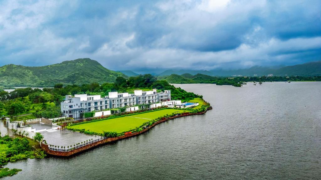 an aerial view of a building on a island in the water at ZANA Lakeview Resort - most scenic lakeside resort in Udaipur