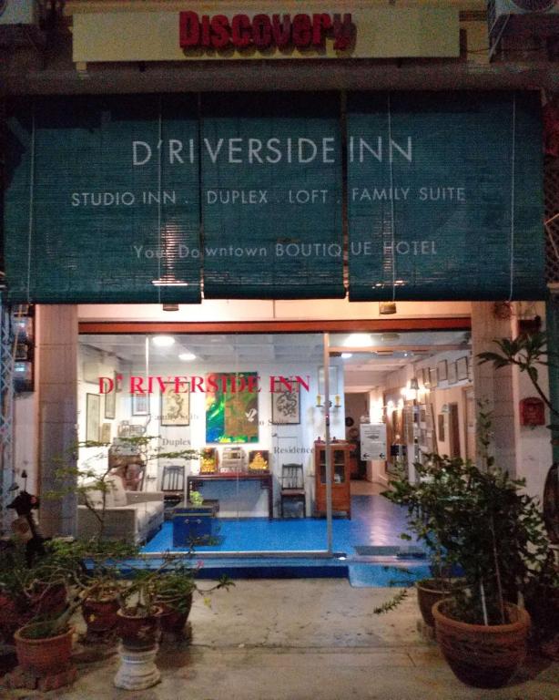 a building with a sign on the front of it at D Riverside Inn in Malacca