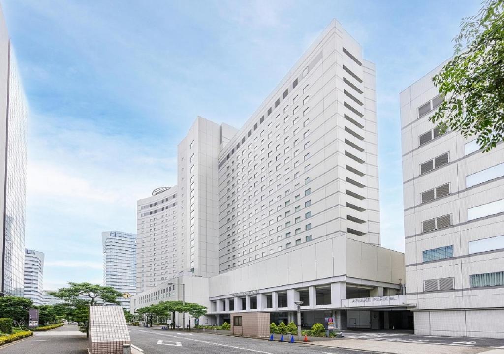 a large white building in a city at Tokyo Bay Ariake Washington Hotel in Tokyo