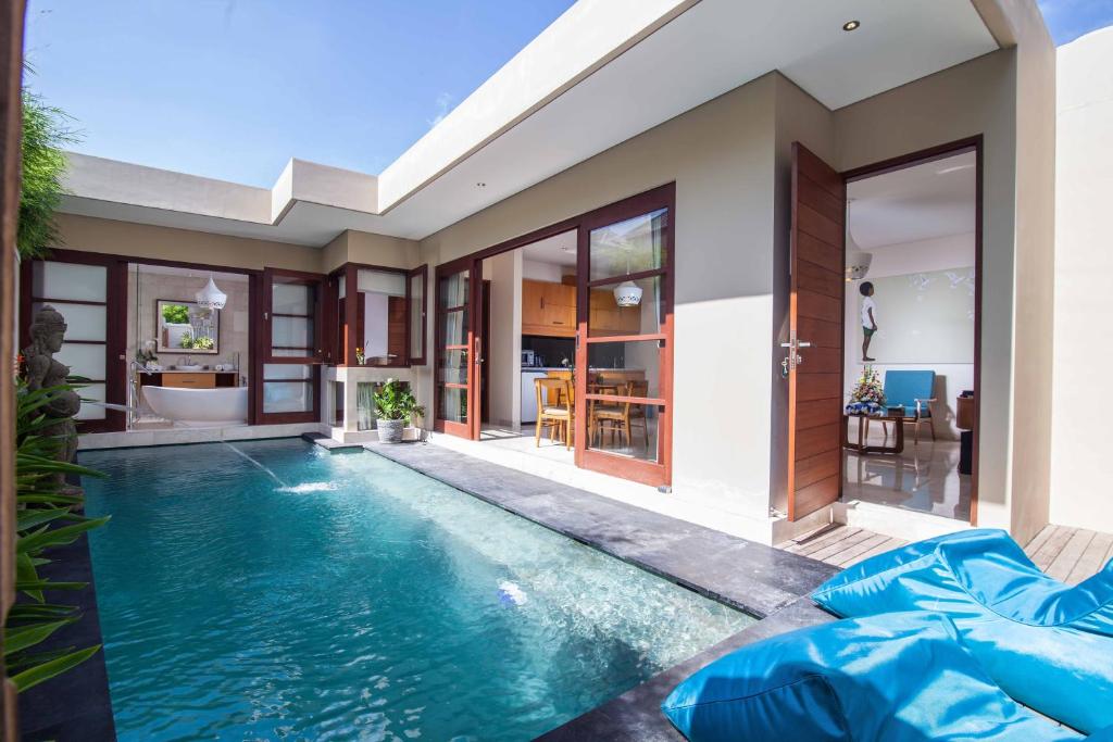 a swimming pool in the backyard of a house at Beautiful Bali Villas in Legian