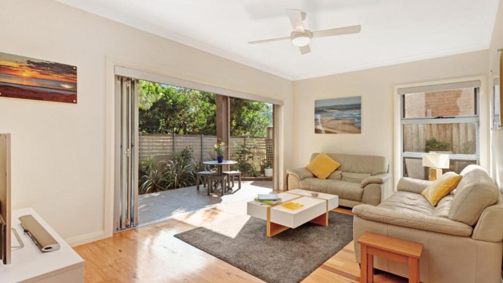 a living room with a couch and a table at Binda Beauty in Hawks Nest