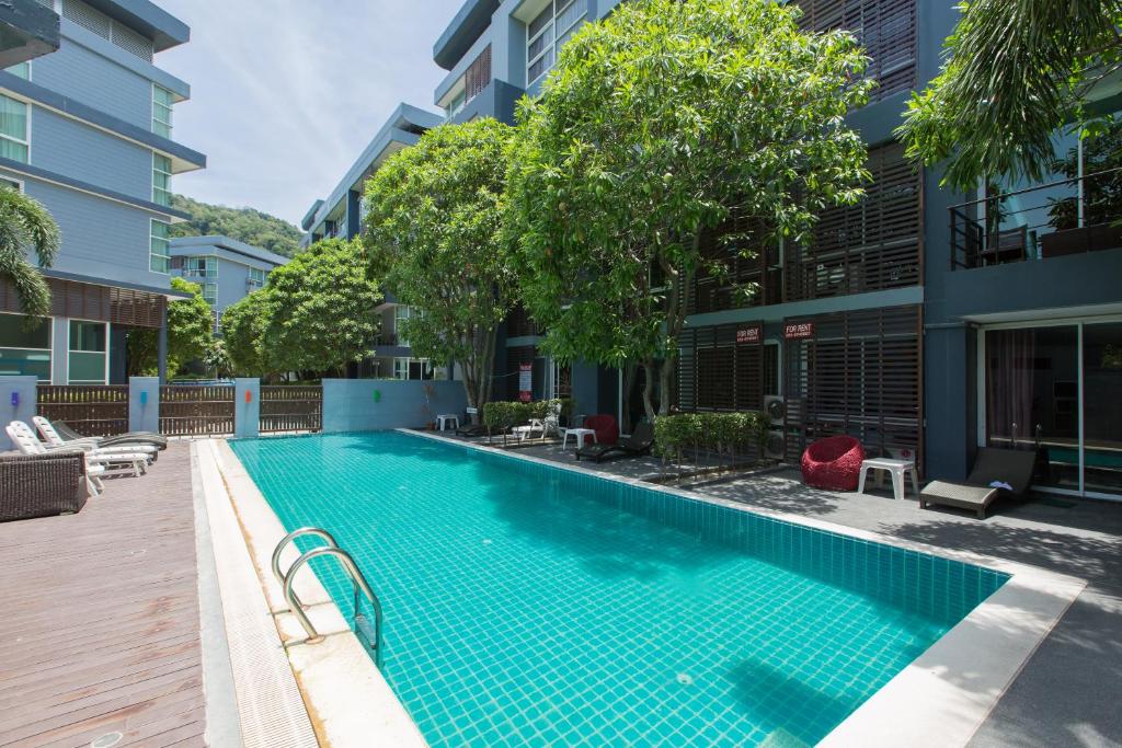 a swimming pool in the middle of a building at Kris - Modern Spacious 2 Bedroom Condo with Pool in Patong Beach