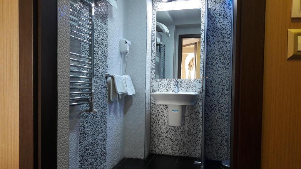 A dressing nook with full-length mirror and parquet floors