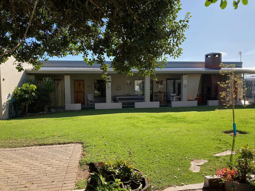 a house with a lawn in front of it at Barrys Guesthouse in Witsand