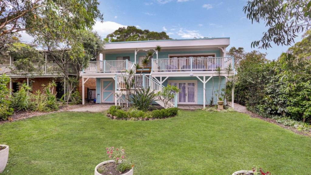 an exterior view of a house with a yard at Driftwood in Hawks Nest
