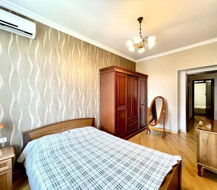 a bedroom with a bed and a dresser in it at Cascade Residence in Yerevan