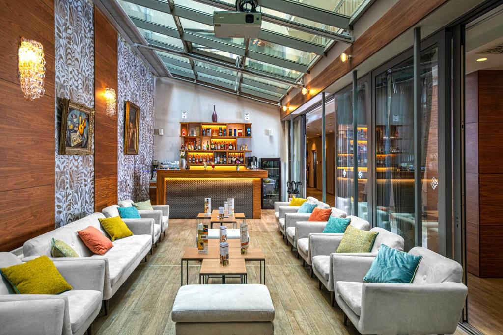 a lobby with couches and tables in a building at Boutique Hotel Budapest in Budapest