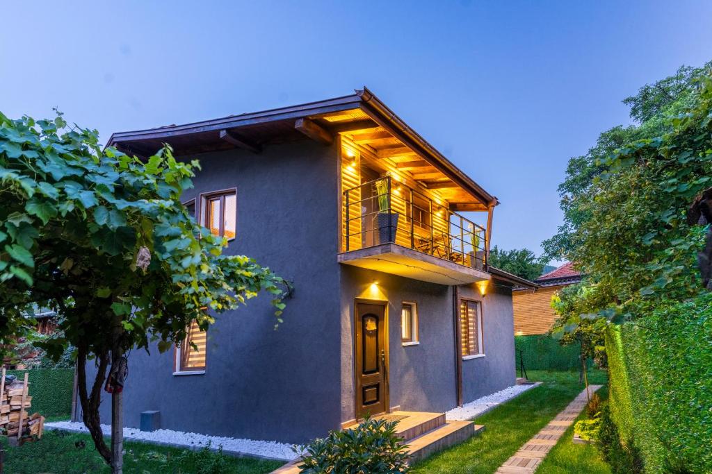 a house with a balcony on the side of it at Guest house Anna-Maria in Velingrad