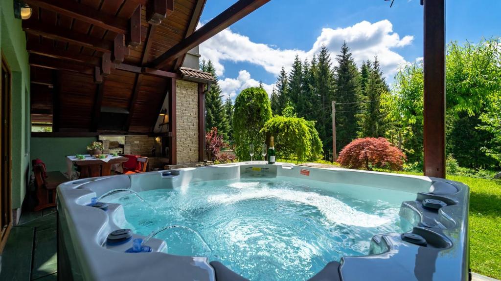 a hot tub in a backyard with a view at Gorska Vila in Mrkopalj