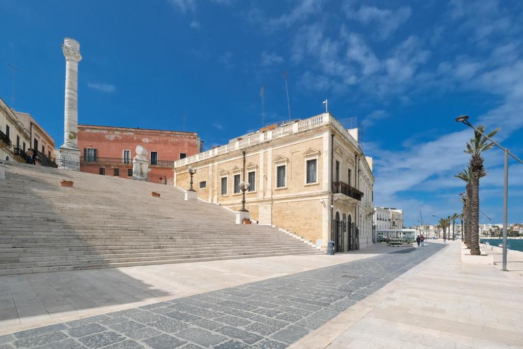 a building on a street with stairs in front at B&B Porta Napoli in Brindisi