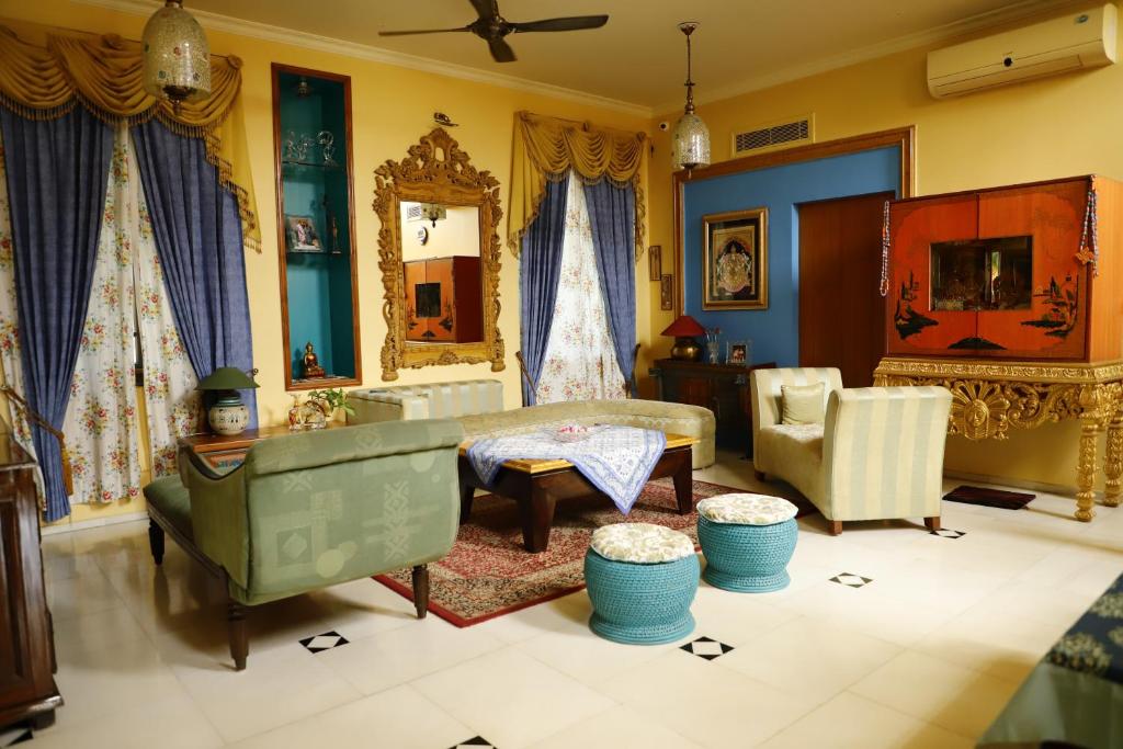a living room with a couch and a table at Aura Homestay Royal Villa in Jaipur