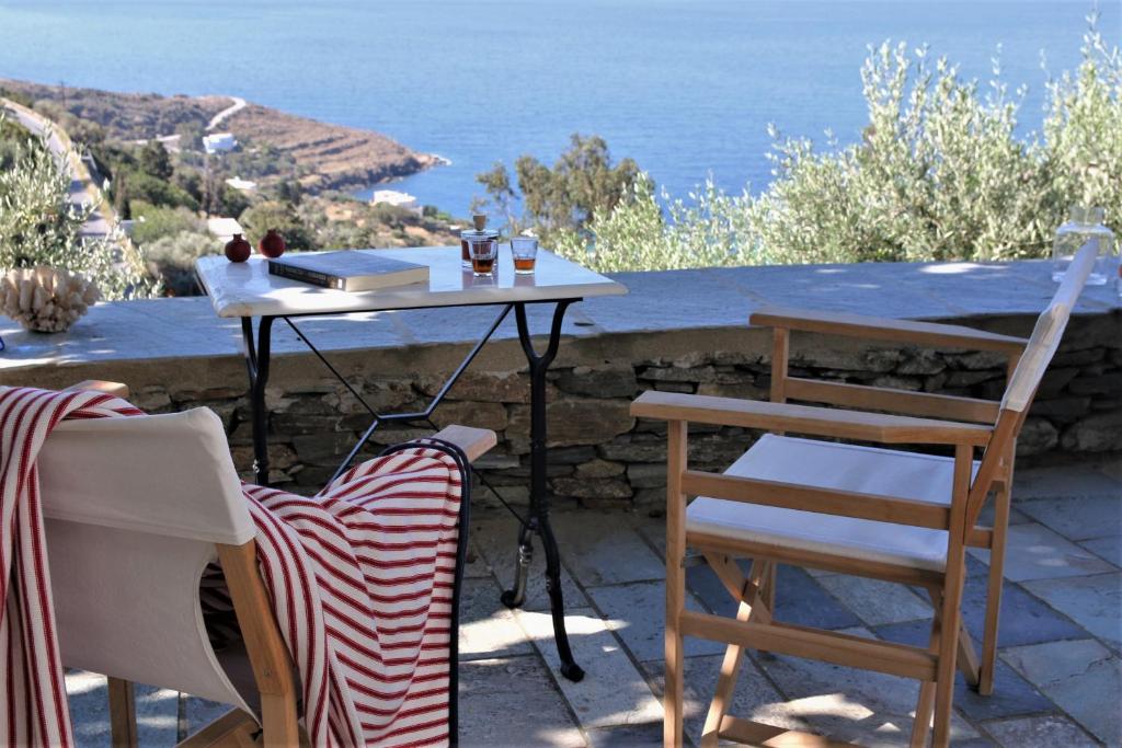 a table and chairs with a view of the ocean at Sea view studio in Batsi