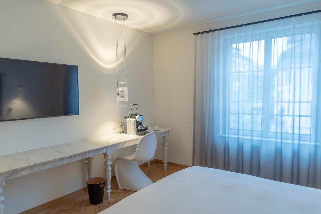 Postel nebo postele na pokoji v ubytování CASPAR Swiss Quality Hotel
