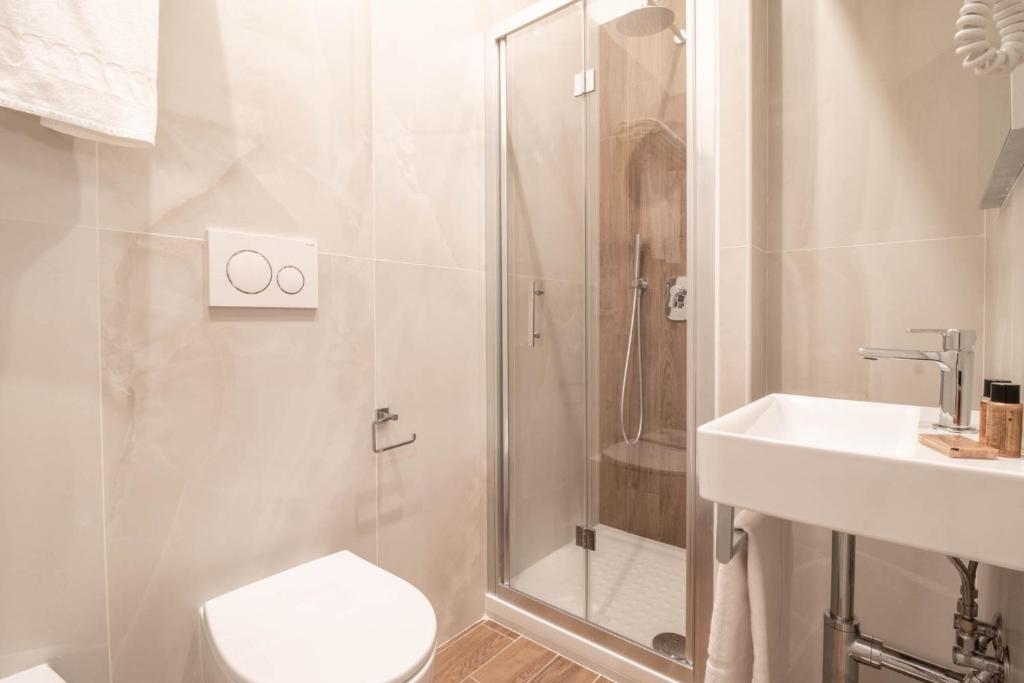 a bathroom with a shower and a toilet and a sink at DANY GUEST HOUSE in Rome