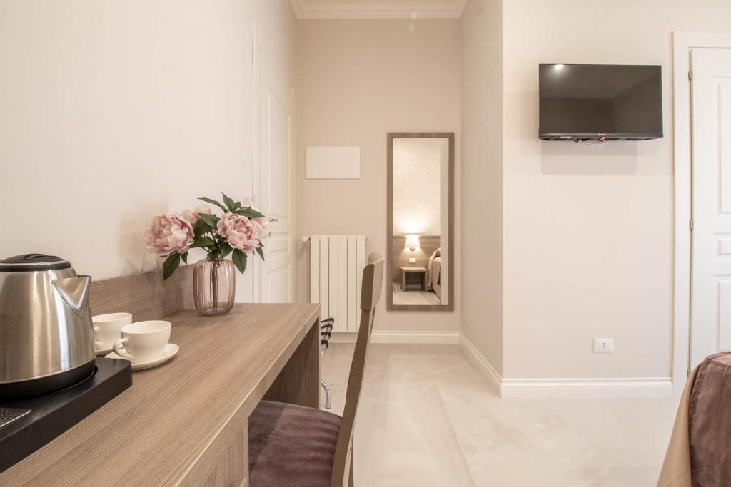 a kitchen with a counter with a vase of flowers at DANY GUEST HOUSE in Rome