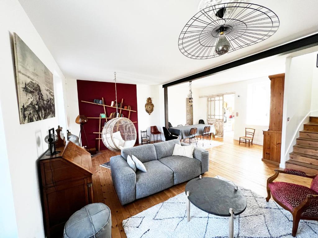 a living room with a couch and a table at Villa Sainte Claire in Saint Malo