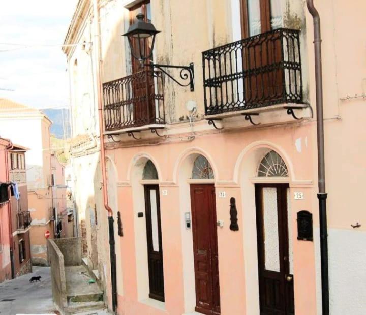 a pink building with a balcony and two doors at The View in Iglesias