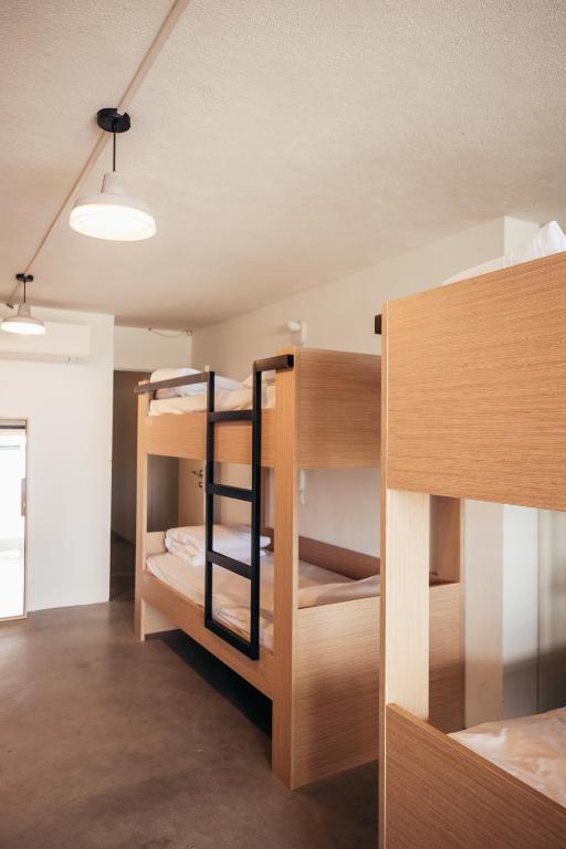 a room with wooden bunk beds in a room at MUTE Hostel Porto Covo in Porto Covo
