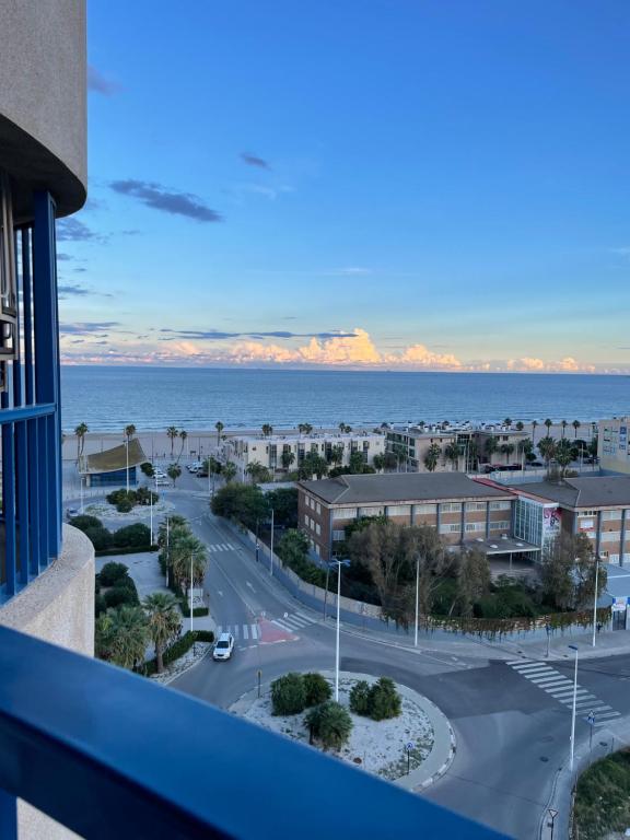 a view of the ocean from a balcony of a building at Ático frente al mar, PataconaBlue, complejo vacacional in Valencia