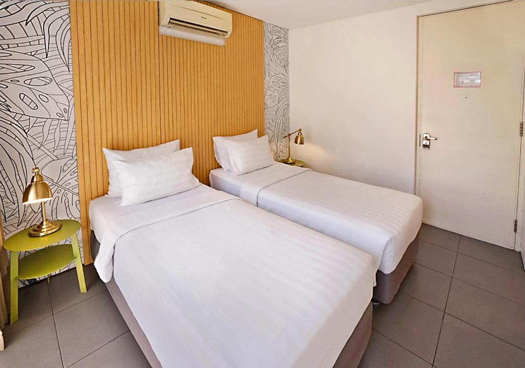 Postel nebo postele na pokoji v ubytování Malaka Hotel Bandung
