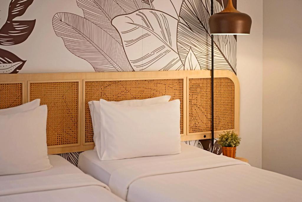 Postel nebo postele na pokoji v ubytování Malaka Hotel Bandung