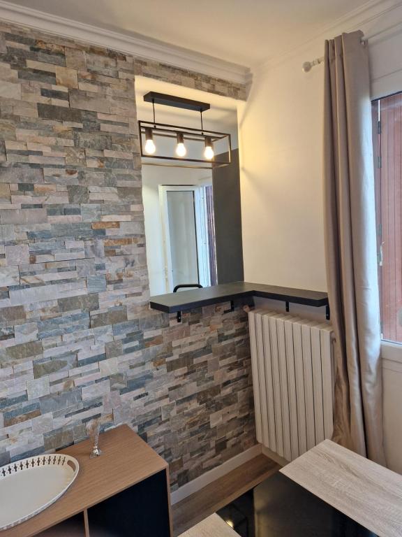 bagno con specchio e lavandino di Appartement spacieux rénové - 11 min de Paris a Colombes