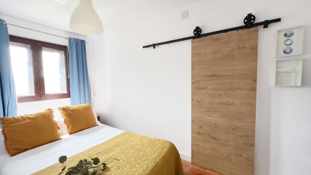 a bedroom with a bed and a wooden wall at Casa Alquife in Sierra Nevada