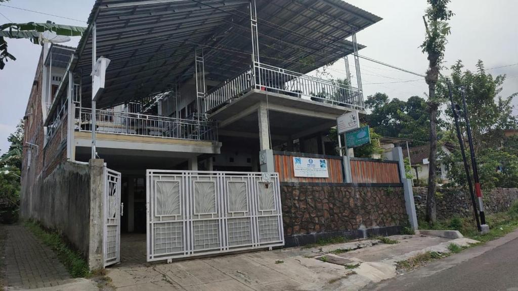 a building with a gate in front of it at kopi ABG in Lawang