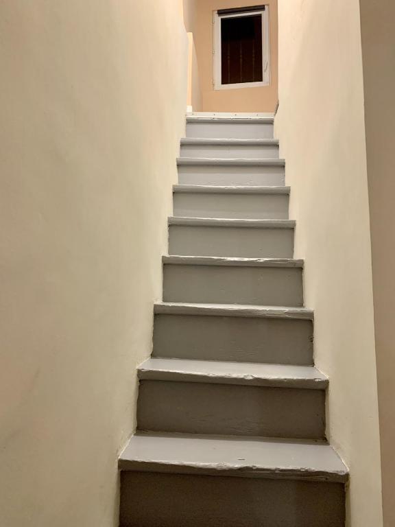 a stairway with a window in a white wall at Perpignan - Appartement en centre ville in Perpignan