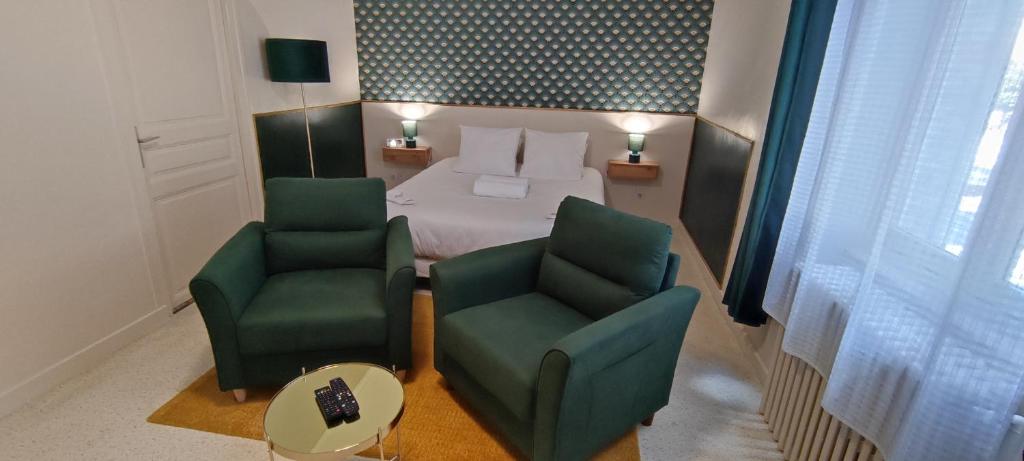Habitación de hotel con 1 cama y 2 sillas en Guest Home location, en Néris-les-Bains