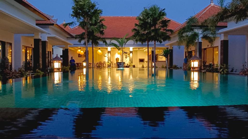 a swimming pool in front of a villa at Kubu Garden Suites & Villas Nusa Dua in Nusa Dua