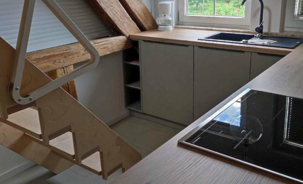 a staircase leading up to a kitchen with a sink at Hof Gruebler in Klipphausen