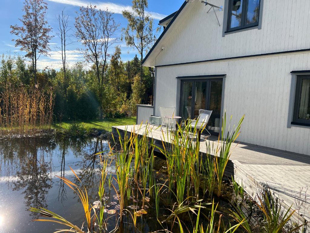 a house with a dock next to a body of water at Ava645 Mira in Söråker