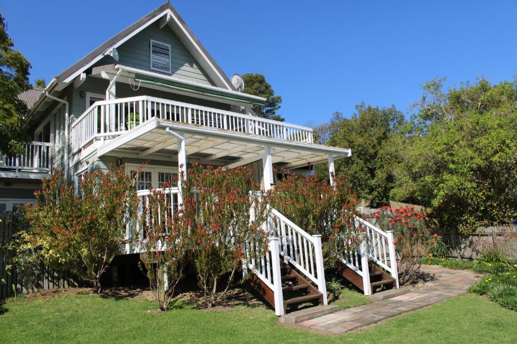 a house with a porch with white railings at 14 Mount Joy in Knysna