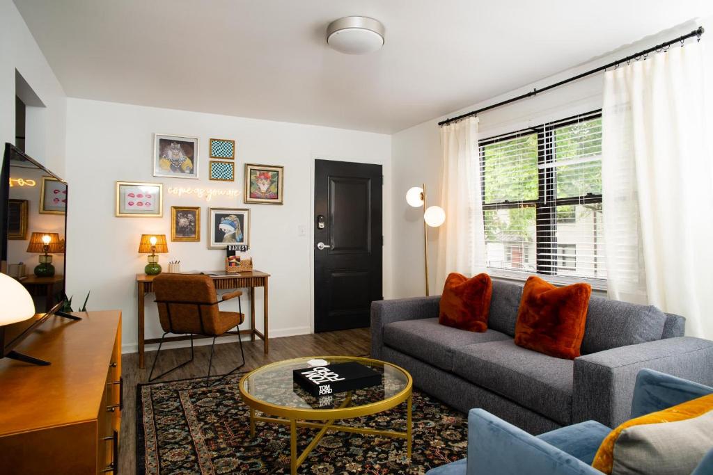 a living room with a couch and a table at Abode Nashville - Marathon Village Near Downtown in Nashville