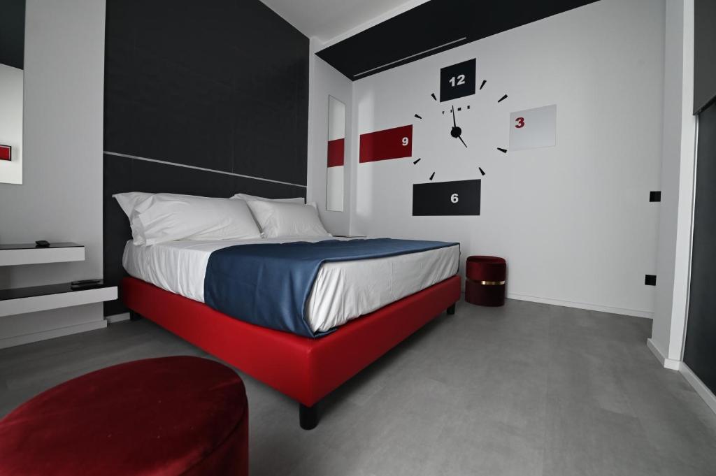 a bedroom with a bed with a red bed frame at Chic House Matera in Matera