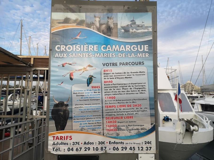 a sign on a dock with boats in a marina at Résidence arc en ciel, proche de la plage accés direct ,internet et parking privatif gratuit in La Grande Motte