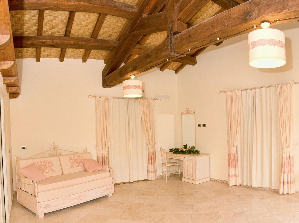 a living room with a couch and a table at Hotel Soffio di Vento in Arbus