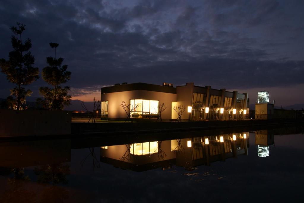 a building with lights in the water at night at Lan Yang Resort Four Seasons in Dongshan