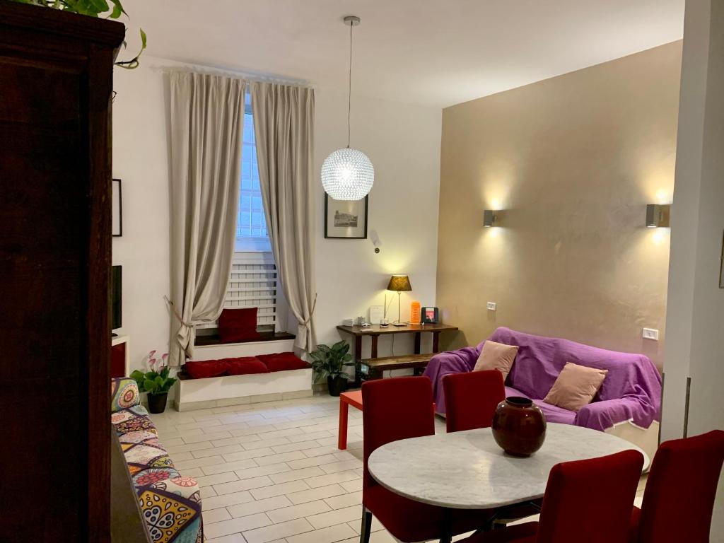 a living room with a purple couch and a table at Chroma Apt Farinone 28 in Rome